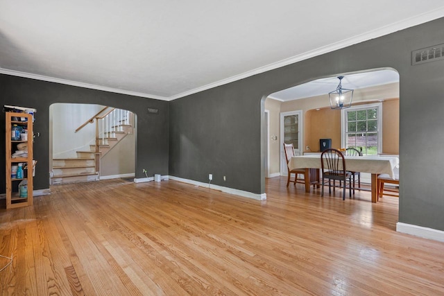 613 Pleasant View St, Wauwatosa, WI 53226 - living area featuring arched walkways, hardwood / wood-style floors, stairway, and ornamental molding