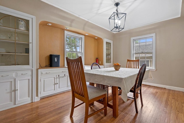 613 Pleasant View St, Wauwatosa, WI 53226 - dining area with light wood finished floors, a chandelier, and crown molding
