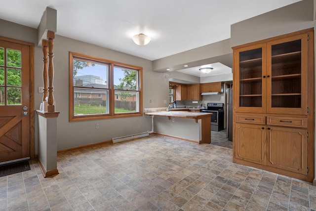 613 Pleasant View St, Wauwatosa, WI 53226 - kitchen with stainless steel appliances, a baseboard heating unit, a peninsula, brown cabinets, and light countertops