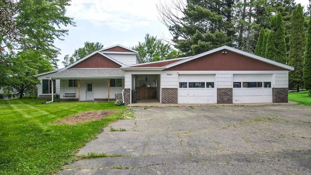 W4976 Pinewood Ln, Merrill, WI 54452 - view of front of home featuring brick siding, a front lawn, and a porch