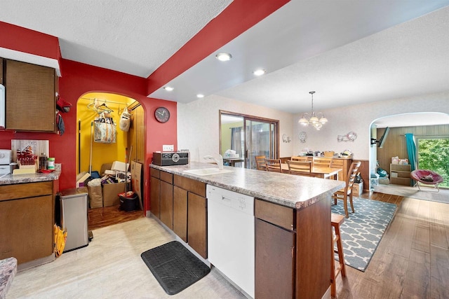 W4976 Pinewood Ln, Merrill, WI 54452 - kitchen with white dishwasher, arched walkways, a peninsula, light wood-style flooring, and recessed lighting