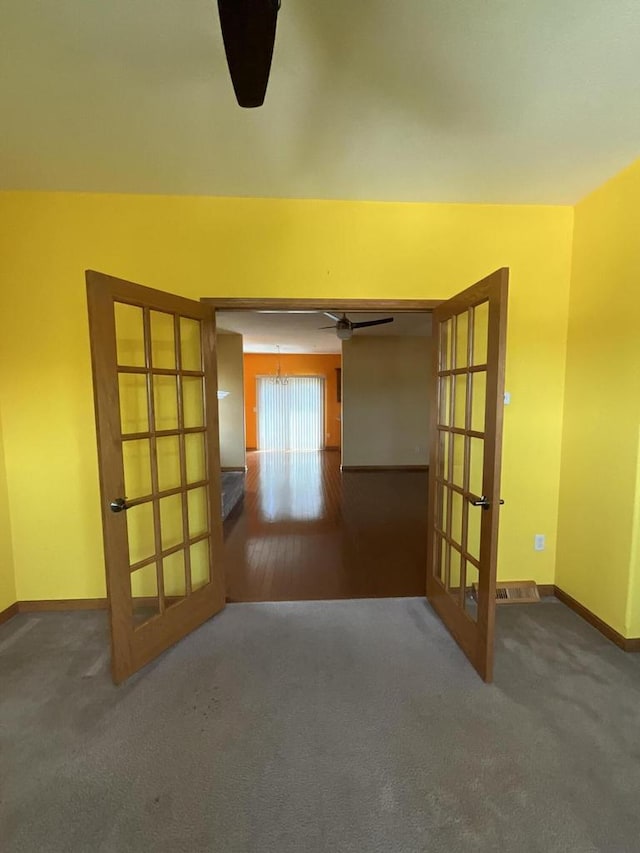 7918 Fredricksburg Ct Unit 101, Bristol, WI 53104 - empty room featuring french doors, a ceiling fan, and carpet flooring