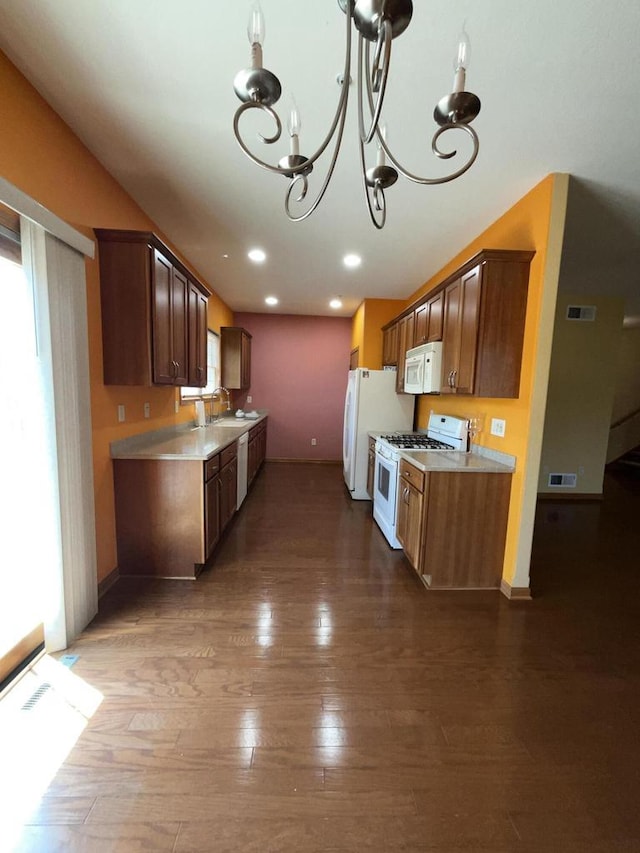 7918 Fredricksburg Ct Unit 101, Bristol, WI 53104 - kitchen featuring white appliances, light countertops, a chandelier, hardwood / wood-style flooring, and recessed lighting