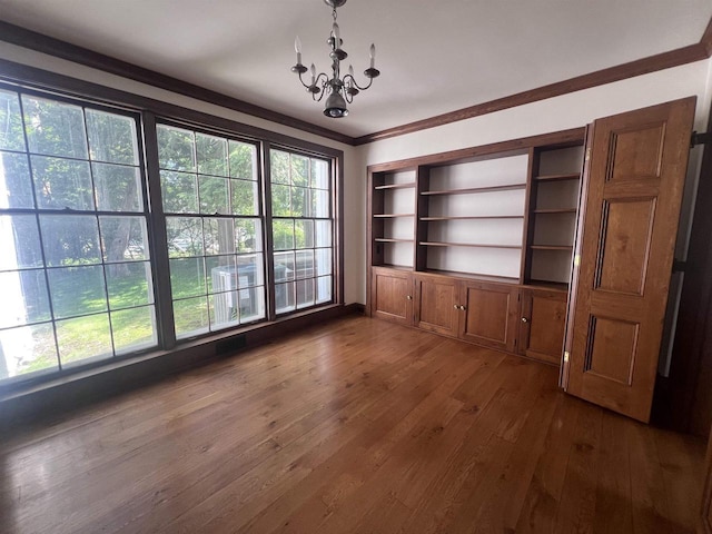 918 Fulton St, Wausau, WI 54403 - unfurnished dining area with a chandelier, dark wood-style floors, and crown molding