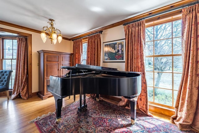 918 Fulton St, Wausau, WI 54403 - living area featuring a chandelier, light wood finished floors, and ornamental molding