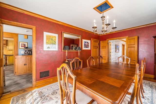 918 Fulton St, Wausau, WI 54403 - dining room with a chandelier, light wood-type flooring, and ornamental molding