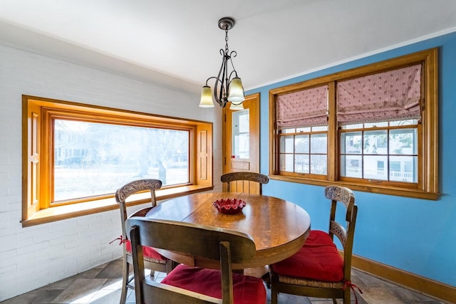 918 Fulton St, Wausau, WI 54403 - dining area with healthy amount of natural light, brick wall, and stone finish floors