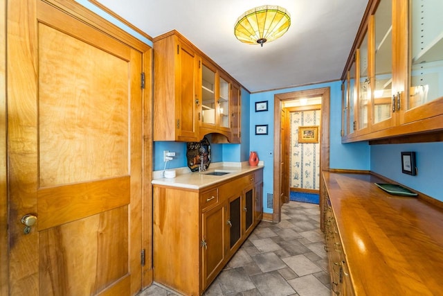 918 Fulton St, Wausau, WI 54403 - kitchen with wooden counters, brown cabinets, and glass insert cabinets