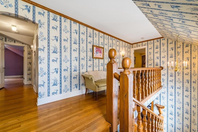 918 Fulton St, Wausau, WI 54403 - stairway with wallpapered walls, wood finished floors, lofted ceiling, and crown molding
