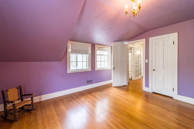 918 Fulton St, Wausau, WI 54403 - unfurnished bedroom with vaulted ceiling, wood finished floors, and a chandelier