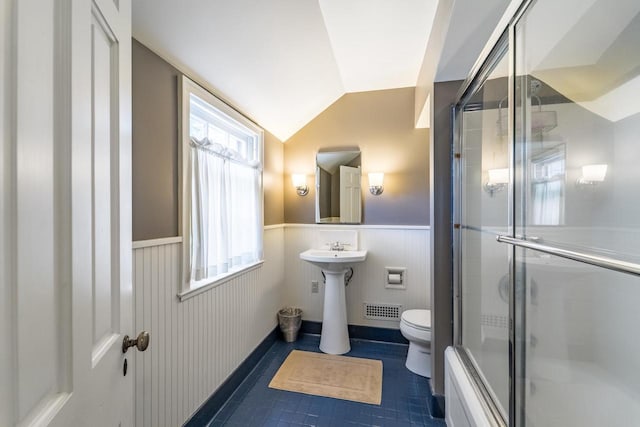 918 Fulton St, Wausau, WI 54403 - full bathroom with wainscoting, vaulted ceiling, tile patterned floors, and shower / bath combination with glass door