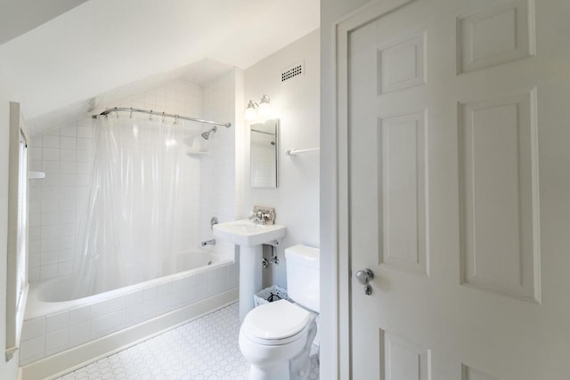 918 Fulton St, Wausau, WI 54403 - bathroom with shower / tub combo, tile patterned floors, and vaulted ceiling