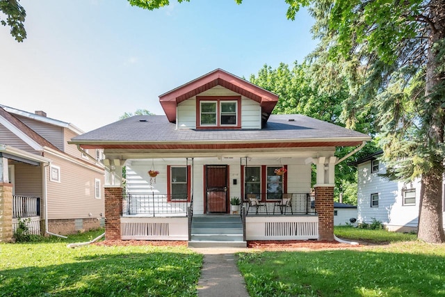 2710 W Fairmount Ave, Milwaukee, WI 53209 - bungalow-style home featuring covered porch, a front yard, and roof with shingles