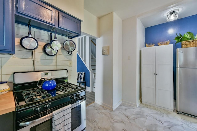2710 W Fairmount Ave, Milwaukee, WI 53209 - kitchen featuring stainless steel appliances, light marble finish flooring, and wooden counters