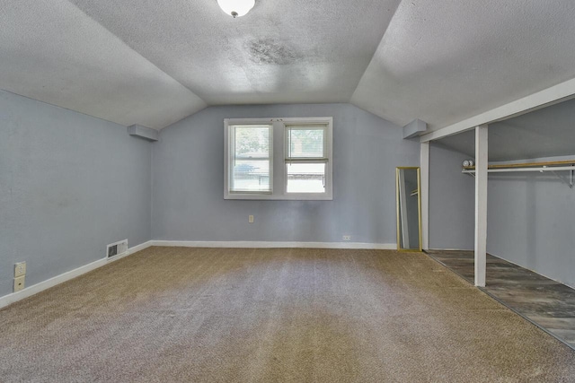 2710 W Fairmount Ave, Milwaukee, WI 53209 - bonus room featuring vaulted ceiling, carpet floors, and a textured ceiling