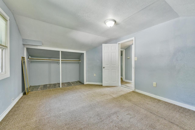 2710 W Fairmount Ave, Milwaukee, WI 53209 - unfurnished bedroom featuring vaulted ceiling, carpet floors, a textured ceiling, and a closet