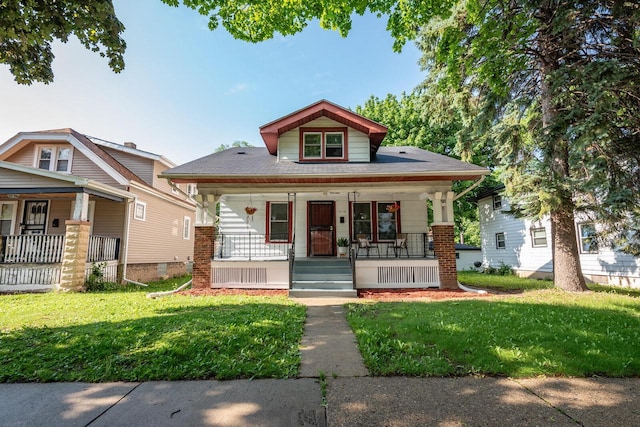 2710 W Fairmount Ave, Milwaukee, WI 53209 - bungalow-style home featuring covered porch and a front lawn