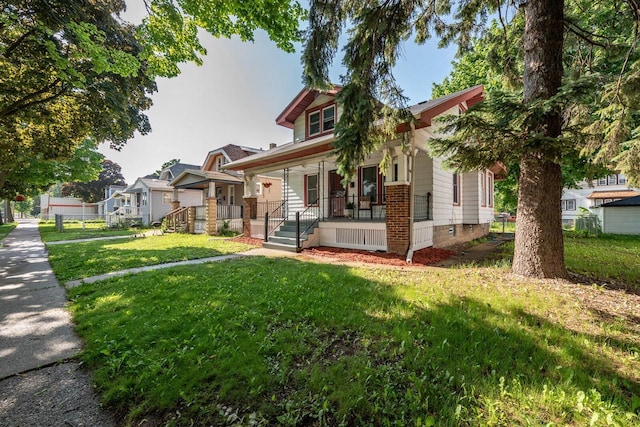 2710 W Fairmount Ave, Milwaukee, WI 53209 - bungalow featuring covered porch and a front lawn