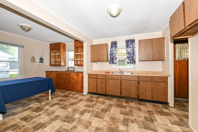 6148 N 38th St, Milwaukee, WI 53209 - kitchen featuring brown cabinetry, light countertops, stone finish floors, and ornamental molding