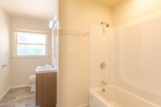 7309 S 46th St, Franklin, WI 53132 - full bath featuring wood finished floors, vanity, and washtub / shower combination
