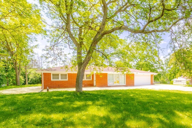 7309 S 46th St, Franklin, WI 53132 - single story home with an attached garage, driveway, a front yard, and brick siding
