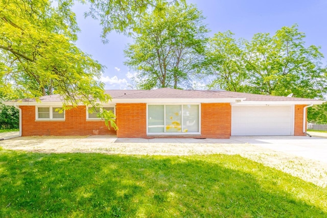 7309 S 46th St, Franklin, WI 53132 - ranch-style home with a front yard, an attached garage, driveway, and brick siding