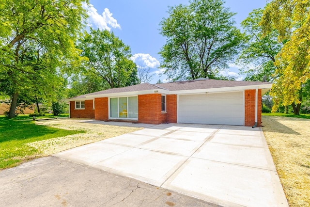 7309 S 46th St, Franklin, WI 53132 - ranch-style house with an attached garage, driveway, a front yard, and brick siding