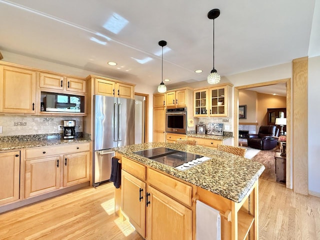 7975 Summit Dr, Delavan, WI 53115 - kitchen with black appliances, light brown cabinets, light wood-style flooring, tasteful backsplash, and glass insert cabinets
