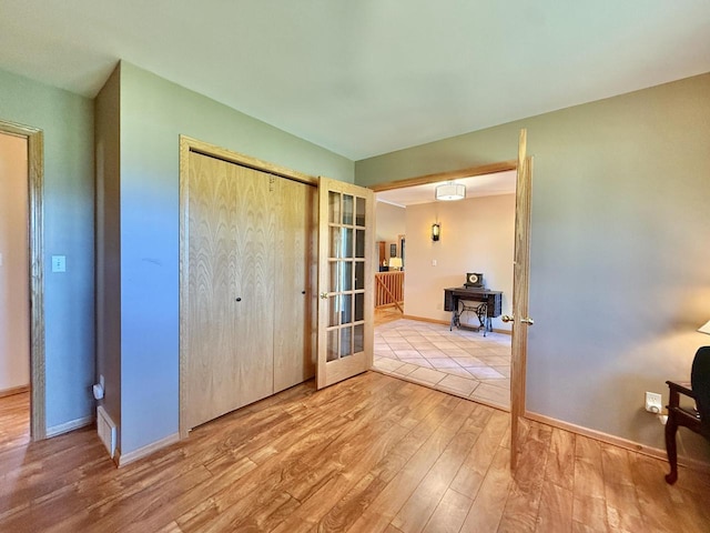 7975 Summit Dr, Delavan, WI 53115 - unfurnished bedroom featuring wood finished floors, french doors, and a closet