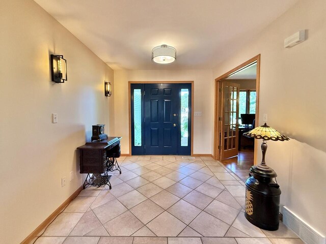 7975 Summit Dr, Delavan, WI 53115 - foyer entrance featuring light tile patterned floors and baseboards