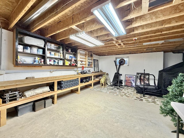 7975 Summit Dr, Delavan, WI 53115 - unfinished below grade area with a wood stove and a workshop area