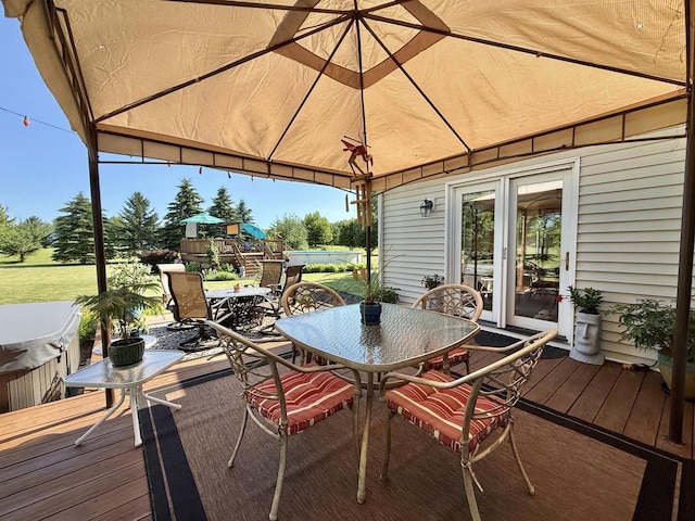 7975 Summit Dr, Delavan, WI 53115 - wooden terrace with outdoor dining space, a hot tub, and a gazebo
