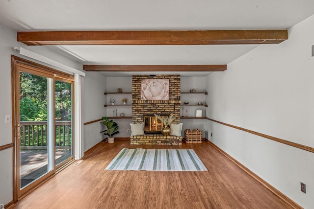 1512 David Ln, Waukesha, WI 53189 - unfurnished room with wood finished floors, beam ceiling, and a fireplace