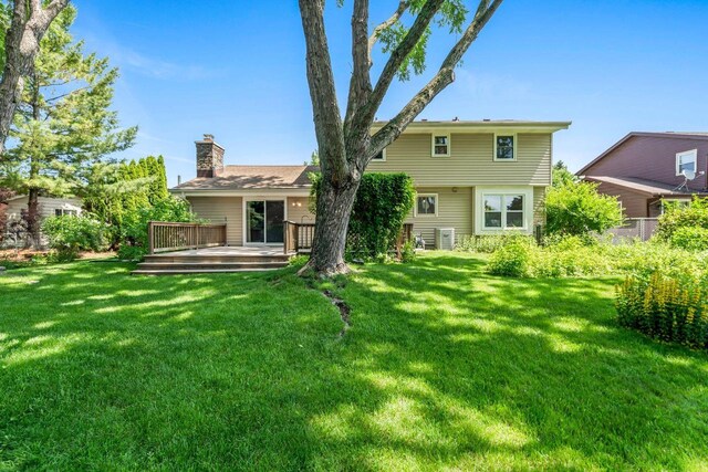 1512 David Ln, Waukesha, WI 53189 - back of property featuring a chimney, a wooden deck, and a yard