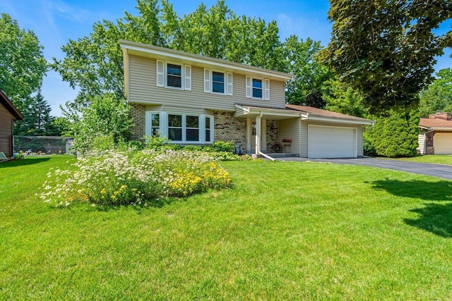 1512 David Ln, Waukesha, WI 53189 - view of front of property featuring driveway, an attached garage, brick siding, and a front yard