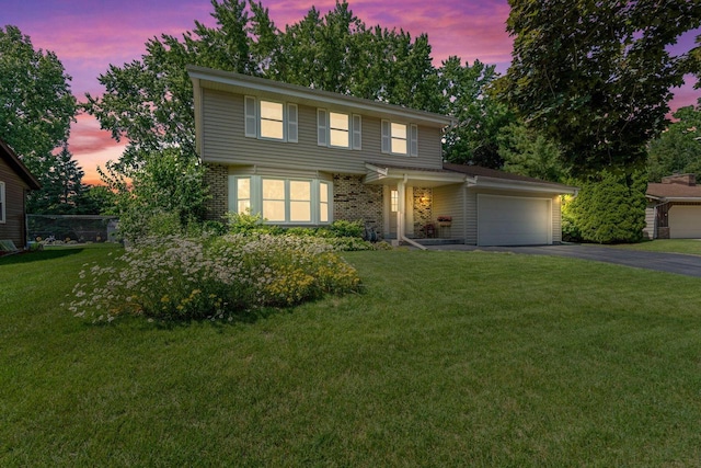 1512 David Ln, Waukesha, WI 53189 - view of front of house with asphalt driveway, a garage, a lawn, and brick siding