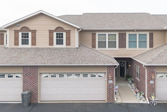 W162S7013 Olive Cir, Muskego, WI 53150 - view of front of house with roof with shingles, brick siding, and driveway