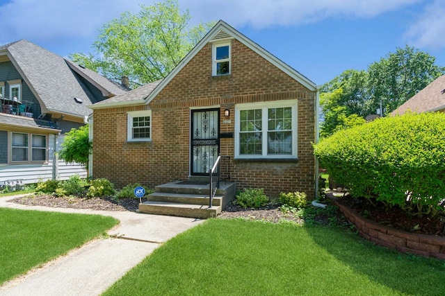 6421 W Girard Ave, Milwaukee, WI 53210 - bungalow featuring brick siding and a front lawn