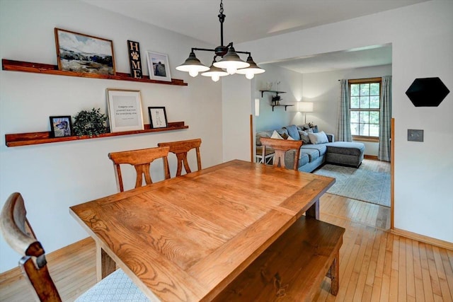 130 W Windsor Ave, Cottage Grove, WI 53527 - dining room featuring light wood finished floors and a chandelier