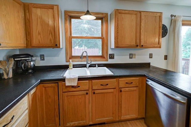 130 W Windsor Ave, Cottage Grove, WI 53527 - kitchen featuring dishwasher, dark countertops, brown cabinetry, and pendant lighting