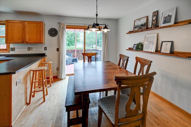 130 W Windsor Ave, Cottage Grove, WI 53527 - dining area with light wood finished floors and a chandelier