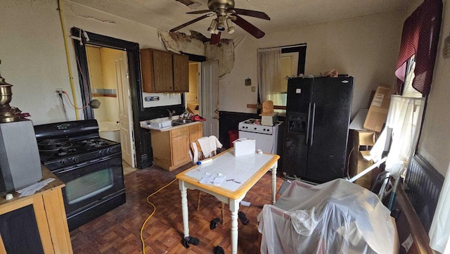 2622 W Vine St, Milwaukee, WI 53205 - kitchen with black appliances, ceiling fan, brown cabinetry, and light countertops