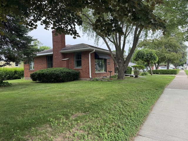 34 Elm Street N, St, La Crescent, MN 55947 - view of side of property featuring a chimney, brick siding, and a lawn