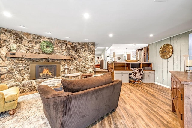 1450 Weber Ct, Hartland, WI 53029 - living area with light wood-style flooring, a fireplace, and wood walls