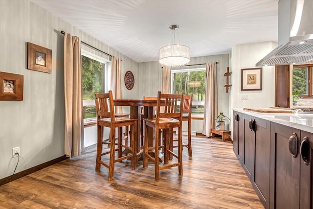 1450 Weber Ct, Hartland, WI 53029 - dining area with healthy amount of natural light, light wood-style flooring, and a chandelier