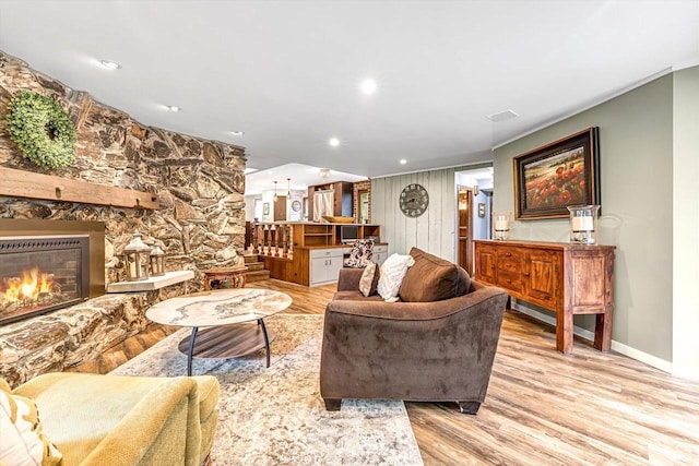 1450 Weber Ct, Hartland, WI 53029 - living area featuring a stone fireplace, light wood-type flooring, and recessed lighting