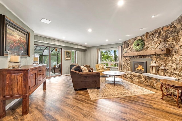 1450 Weber Ct, Hartland, WI 53029 - living area with wood finished floors, a stone fireplace, recessed lighting, and ornamental molding