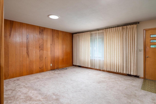 3720 Elm Dr, La Crosse, WI 54601 - spare room with carpet and wood walls