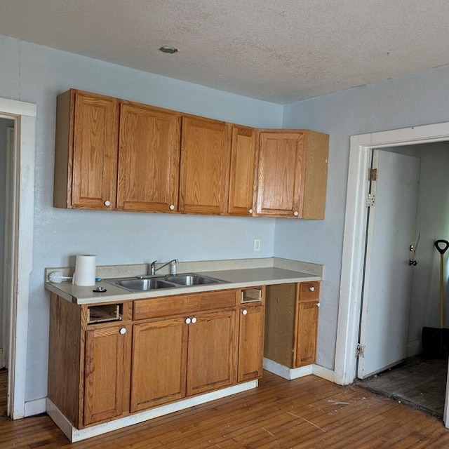 1920 W Vienna Ave, Milwaukee, WI 53206 - kitchen featuring brown cabinets, dark wood-style floors, light countertops, and a textured ceiling