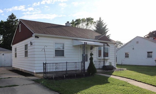2218 Jerome Blvd, Racine, WI 53403 - bungalow-style home with a front yard, a chimney, roof with shingles, and a garage